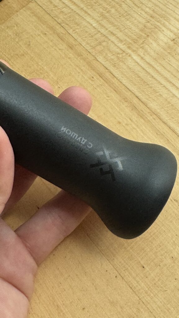 Dampfer für Shisha mit schwarzem Griff auf Holzoberfläche.