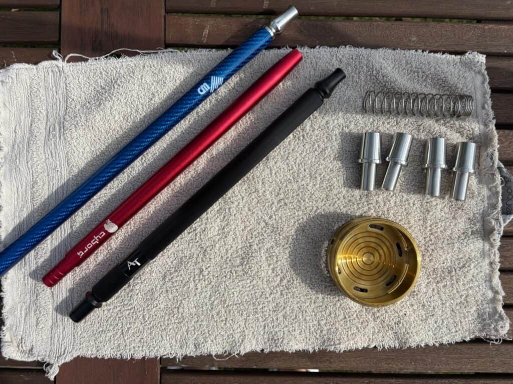 Verschiedene Shisha-Teile und Zubehör auf Handtuch.