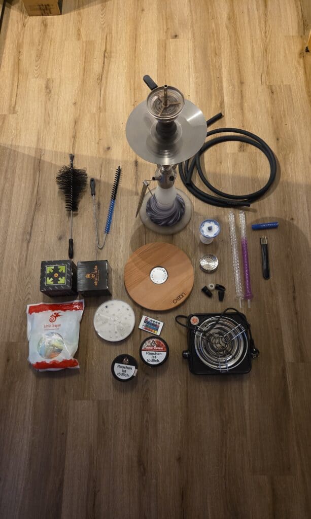 Verschiedene Shisha Teile, Glasbowl, Reinigungsbürste, Kohlezange, Tabakdosen.