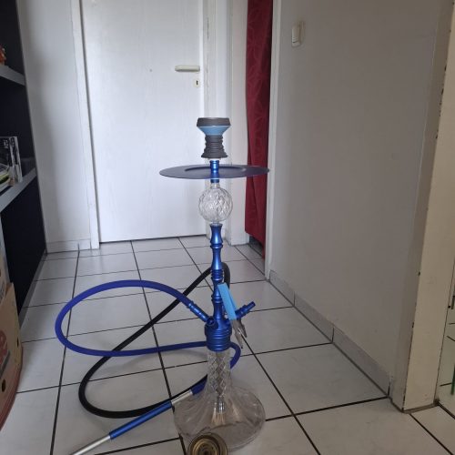 Rauchpfeife mit Glas und blauer Rauchsäule, geeignet für Shisha-Genuss.