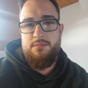 Mann mit Brille und dunklem Hoodie, Nahaufnahme.