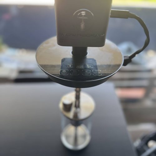 Elektronischer Shisha-Zubehörtester auf einer Oberfläche mit Kabel verbunden.