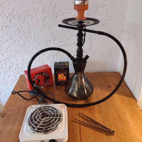 Shisha mit Heizgerät, Kohle und Zubehör auf Holz.