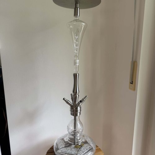 Moderne Shisha mit Glasbowl und Metallteilen auf Holztablett.