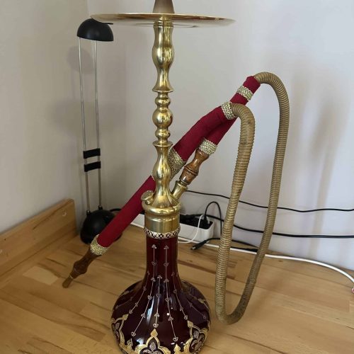 Hochwertige Wasserpfeife mit goldener Dekoration und rotem Schlauch, ideal für Shisha-Liebhaber.