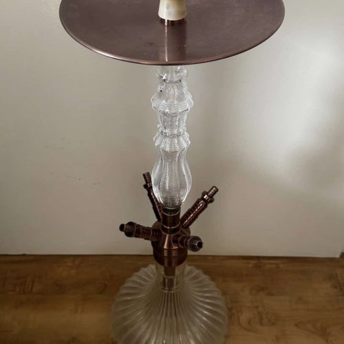 Hookah mit Glas-Base, Metall-Tisch und Deko-Elementen.